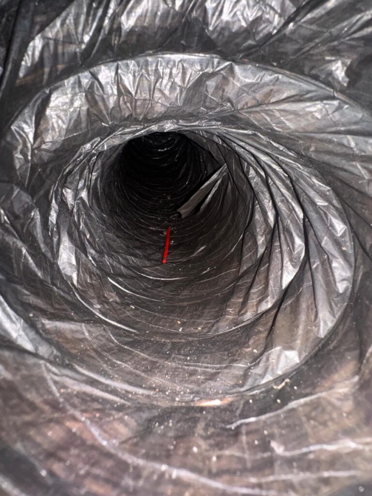 Inside a residential AC duct documented during a Nuvair duct cleaning job
