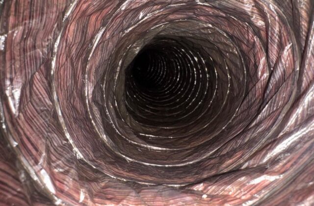 Flexible AC duct interior after cleaning, liner clearly visible